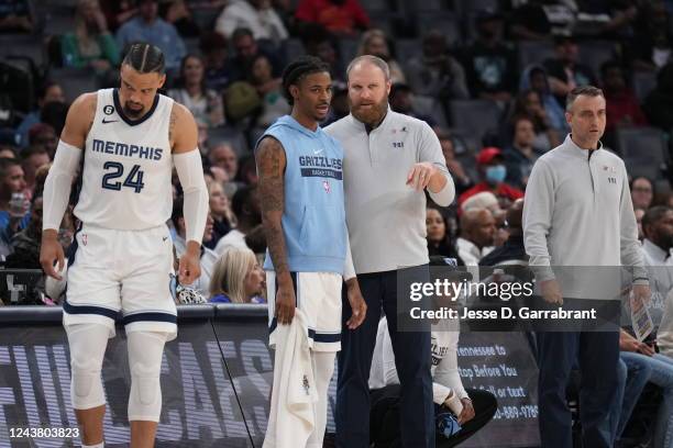 Ja Morant of the Memphis Grizzlies talks with Head Coach Taylor Jenkins of the Memphis Grizzlies during a preseason game on October 7, 2022 at...