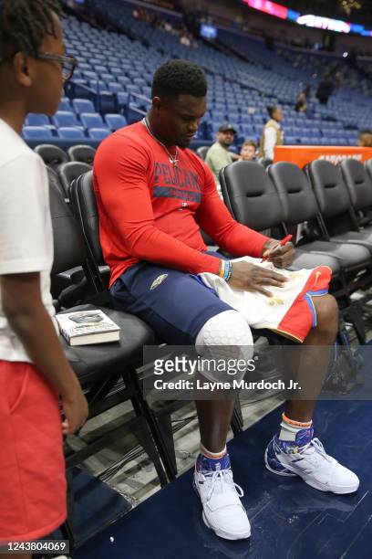 Zion Williamson of the New Orleans Pelicans signs autographs before the game against the Detroit Pistons on October 7, 2022 at the Smoothie King...