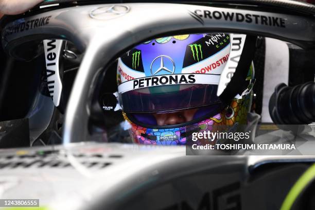 Mercedes' British driver Lewis Hamilton prepares to take part in the third practice session ahead of the Formula One Japanese Grand Prix at Suzuka,...