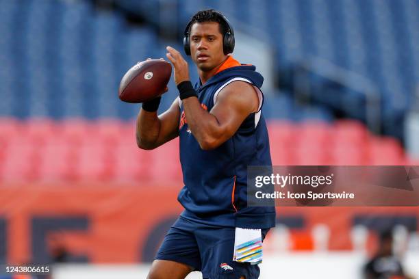 Denver Broncos quarterback Russell Wilson warms up on the field prior to an NFL game between the Indianapolis Colts and the Denver Broncos at Empower...