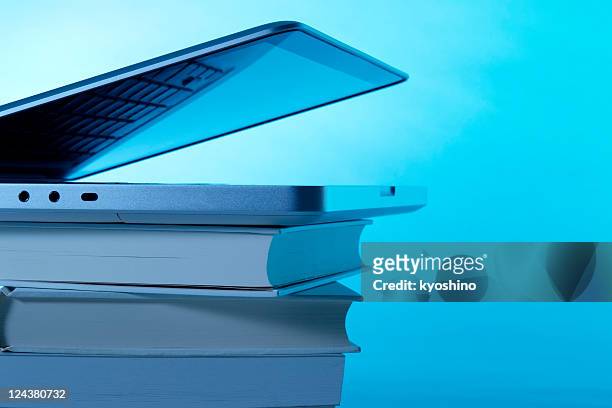 opened laptop on stacked blank books with copy space - book blue bildbanksfoton och bilder
