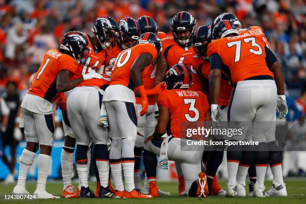 Denver Broncos quarterback Russell Wilson leads an offensive group huddle during an NFL game between the Indianapolis Colts and the Denver Broncos at...