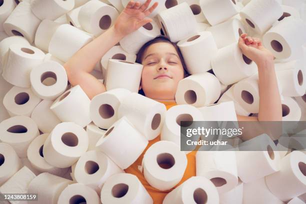 little girl lies in toilet papers - toilet paper stock pictures, royalty-free photos & images