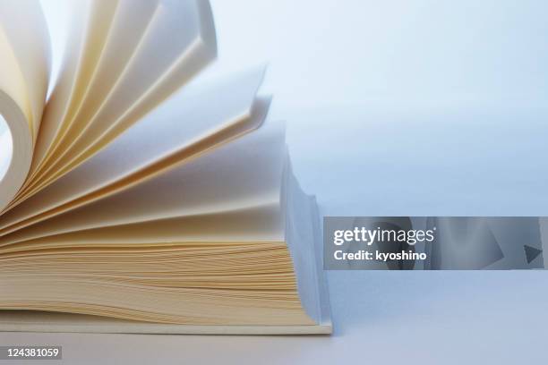 blue tinted image of turning pages of a blank book - pages turning stock pictures, royalty-free photos & images