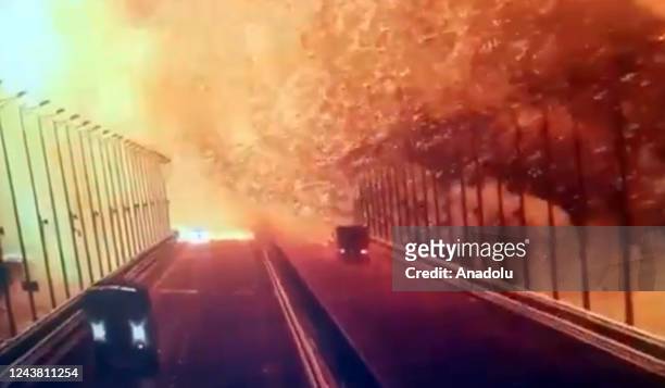 Screen grab from a surveillance footage shows flames and smoke rising up after an explosion at the Kerch bridge in the Kerch Strait, Crimea, October...