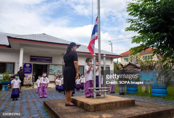 Teachers and children from a day-care centre in Chiang Mai take a minute of silence as they mourn and pay their respects. Police Corporal Panya...