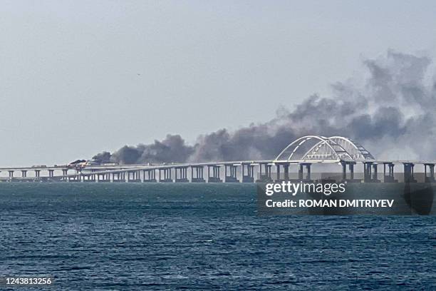 This photograph shows thick black smoke rising from a fire on the Kerch bridge that links Crimea to Russia, after a truck exploded, near Kerch, on...