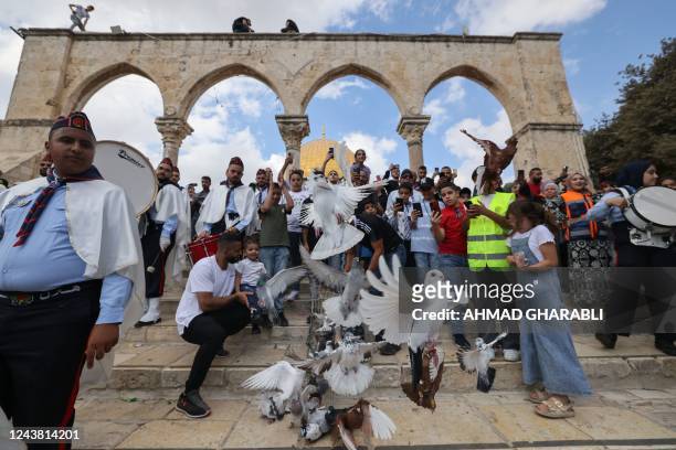 Palestinians release pigeons as they celebrate the birth of Islam's Prophet Mohammed, known in Arabic as the "Mawlid al-Nabawi" holiday, at...