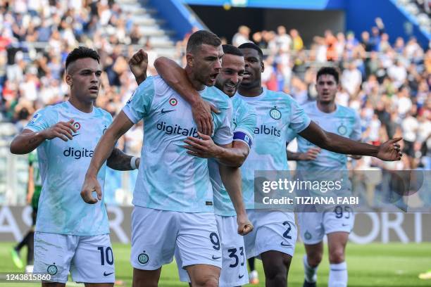 Inter Milan's Bosnian forward Edin Dzeko celebrates with Inter Milan's Argentinian forward Lautaro Martinez , Inter Milan's Italian defender Danilo...