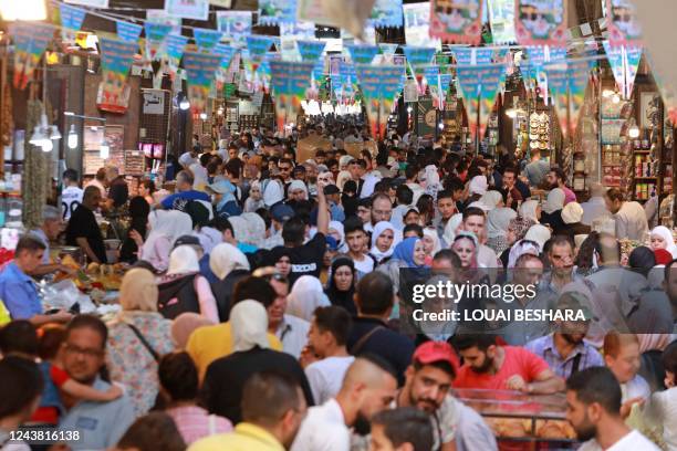 Syrians shop at a market as they celebrate the birth of Islam's Prophet Mohammed, known in Arabic as the "Mawlid al-Nabawi" holiday, in the capital...