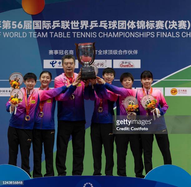 Sun Yingsha, Wang Manyu, coach Li Sun, Chen Meng, Wang Yidi and Chen Xingtong of China lift Corbillon Cup trophy after winning the Women's Final...