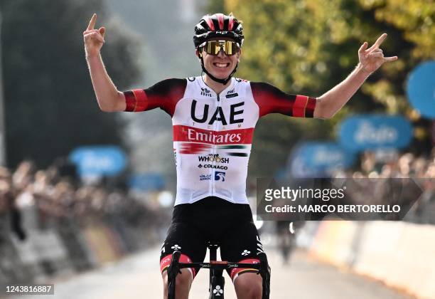 Team Emirates team's Slovenian rider Tadej Pogacar celebrates as he crosses the finish line of the 116th edition of the Giro di Lombardia , a 252,42...