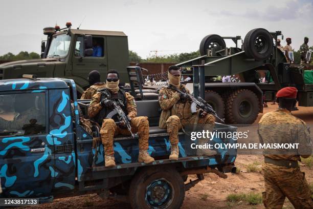 Burkina Faso's servicemen stand guard during the burial of the soldiers killed in Gaskinde, in Ouagadougou on October 8, 2022. - The ambush in...