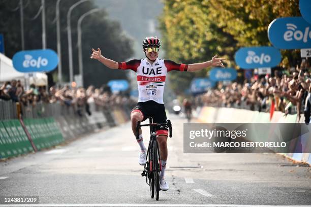 Team Emirates team's Slovenian rider Tadej Pogacar celebrates as he crosses the finish line of the 116th edition of the Giro di Lombardia , a 252,42...