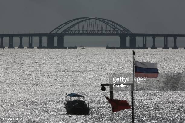 This photograph taken on October 8, 2022 shows the Kerch bridge that links Crimea to Russia after a truck exploaded on the bridge this morning in...