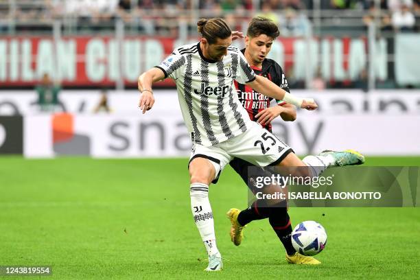 Juventus' French midfielder Adrien Rabiot fights for the ball with AC Milan's Spanish midfielder Brahim Diaz during the Italian Serie A football...