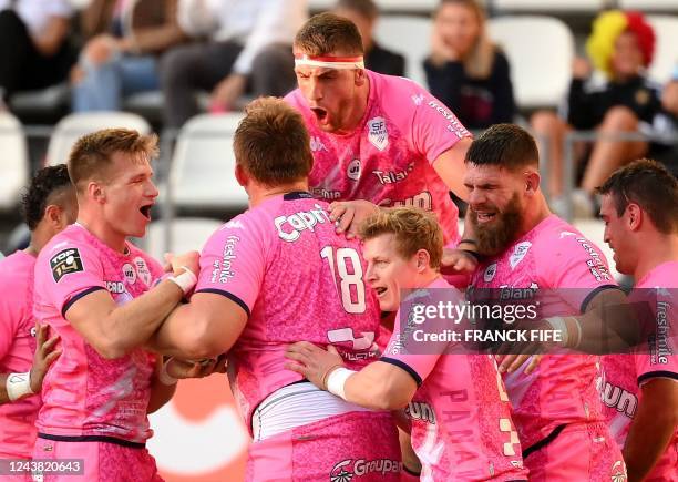 Stade Francais' French prop Mathieu De Giovanni is congratuled by teammates after scoring a try during the French Top14 rugby union match between...