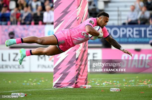 Stade Francais' Australian wing Sefania Naivalu dives to score a try during the French Top14 rugby union match between Stade Francais Paris and...