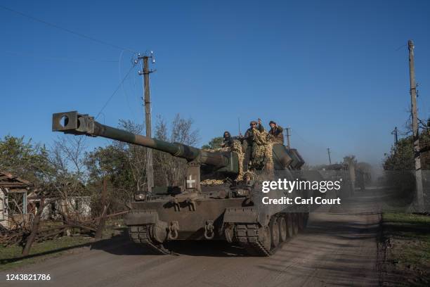 Ukrainian soldiers ride on a Polish Krab self-propelled howitzer on October 08, 2022 in Rubtsi, Ukraine. In recent weeks, Ukrainian forces have...