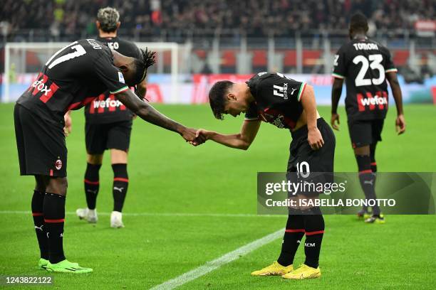 Milan's Spanish midfielder Brahim Diaz celebrates with AC Milan's Portuguese forward Rafael Leao after scoring his team's second goal during the...