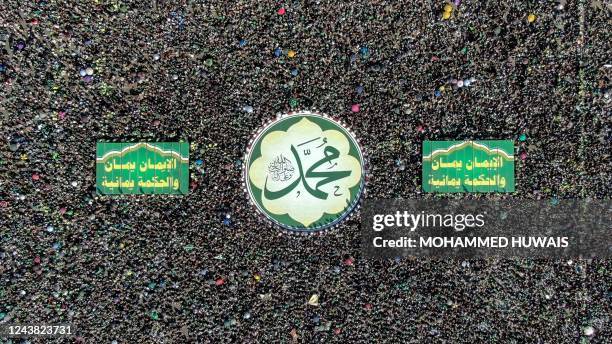 An aerial view shows Yemenis attending a ceremony marking the birth anniversary of Islam's Prophet Mohammad, known in Arabic as "Mawlid al-Nabawi",...