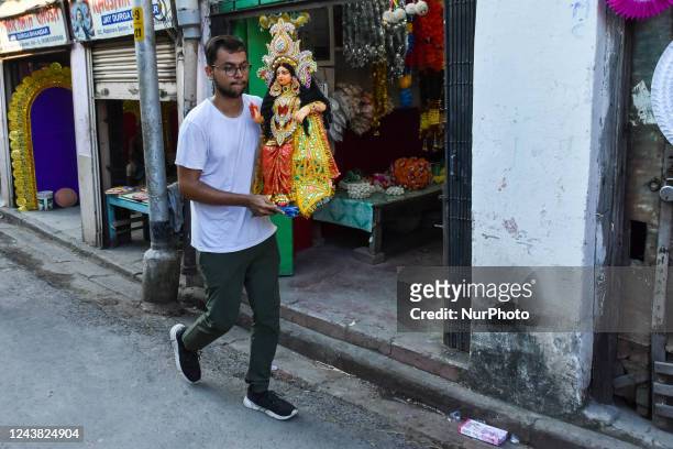 Devotees are seen carrying idols of Goddess Laxmi ahead of Laxmi puja celebration in Kolkata , India , on 8 October 2022 . Lakshmi puja is the...