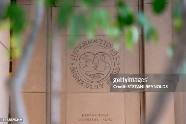 The International Monetary Fund logo is displayed outside its headquarters in Washington, DC, on October 8, 2022. - The IMF will be hosting its...