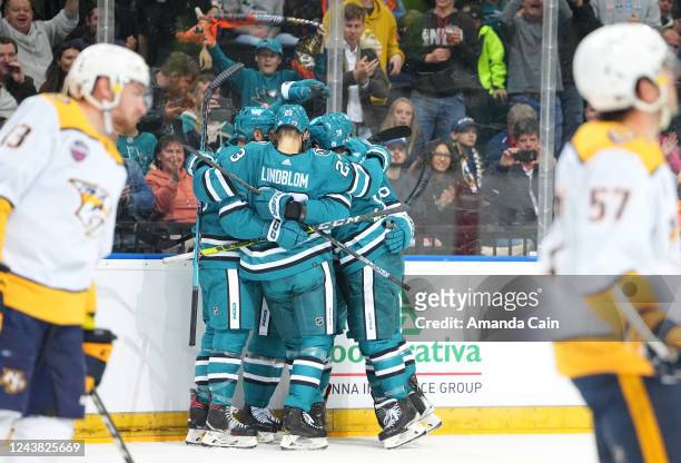 Luke Kunin of the San Jose Sharks celebrates his power play goal with teammates during the first period of the 2022 NHL Global Series Challenge Czech...