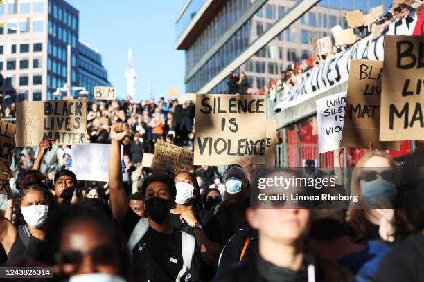 Protesters participate in a demonstration in solidarity with the Black Lives Matter movement and against police brutality at Sergels Torg on June 03,...