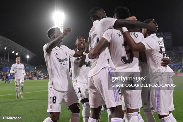 Real Madrid players celebrate their opening goal scored by Real Madrid's Brazilian defender Eder Militao during the Spanish League football match...