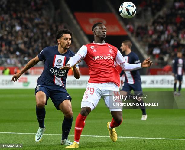 Paris Saint-Germain's Brazilian defender Marquinhos fights for the ball with Reims' English forward Folarin Balogun during the French L1 football...