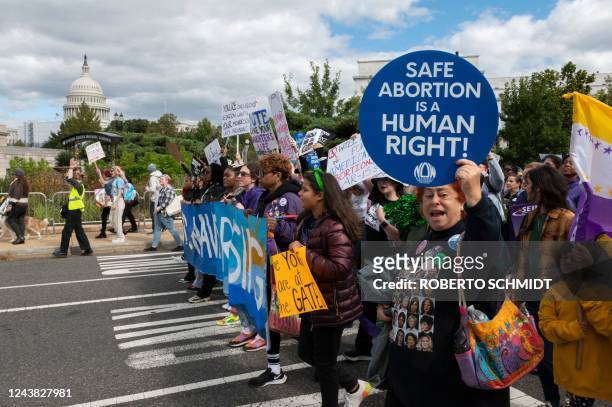 Demonstrators march past the US Capitol during the annual Women's March to support Women's Rights in Washington, DC, October 8, 2022. - Thousands of...