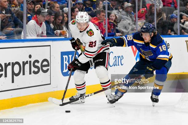 St. Louis Blues center Robert Thomas tries to knock the puck away from Chicago Blackhawks center Philipp Kurashev during a preseason game between the...
