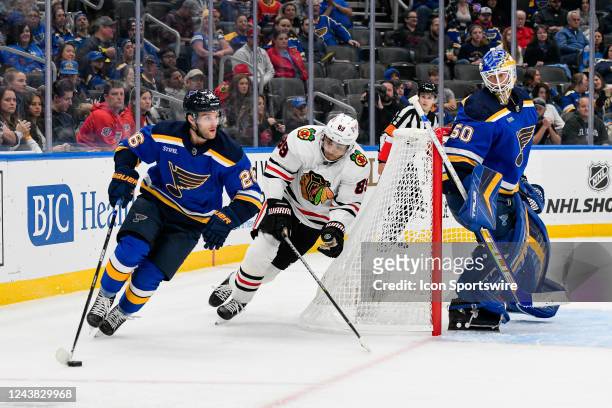 St. Louis Blues left wing Nathan Walker cuts the net short hoping to get away from the forecheck of Chicago Blackhawks center Andreas Athanasiou...