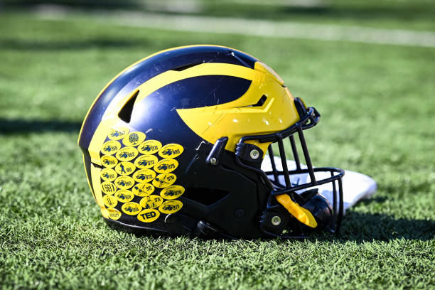 Michigan football helmet sits on the field following a college football game between the Michigan Wolverines and Indiana Hoosiers on October 8, 2022...