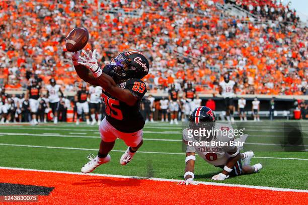Wide receiver Jaden Bray of the Oklahoma State Cowboys gets his fingertips on a pass that could have been a touchdown against defensive back Rayshad...