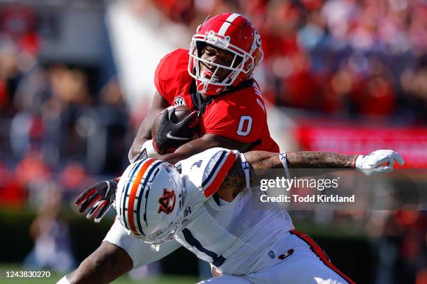 Darnell Washington of the Georgia Bulldogs is tackled by Donovan Kaufman of the Auburn Tigers in the first half at Sanford Stadium on October 8, 2022...