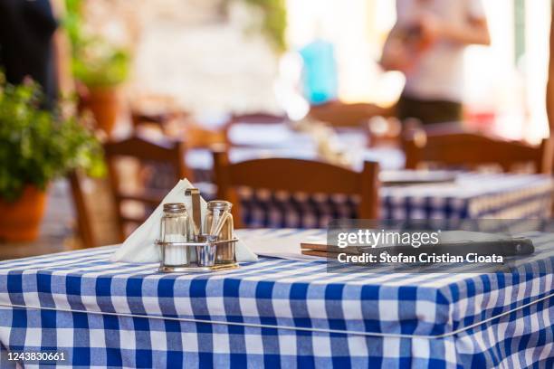 greece ready for tourists. tables on tavern ready for cutomers - plaka greek cafe stock pictures, royalty-free photos & images