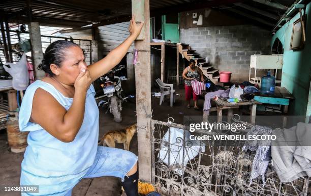 Woman prepares to leave her house at the former banana fields of the municipality of El Progreso, Yoro department, Honduras, before the arrival of...