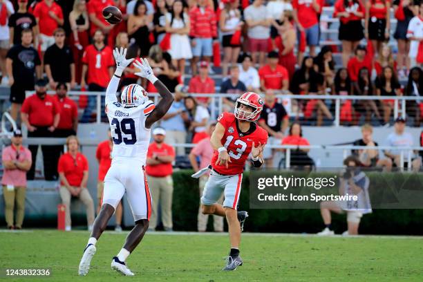 Auburn Tigers linebacker Dylan Brooks leaps to try and deflect the pass of Georgia Bulldogs quarterback Stetson Bennett during the Saturday afternoon...