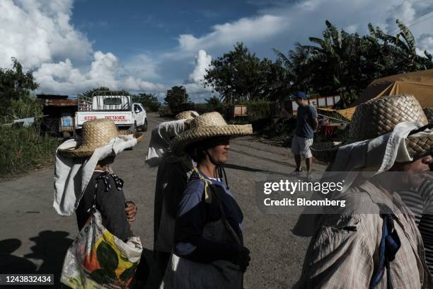 Female farmworkers walk home after working in the fields at a sugarcane farm in Victorias City, Negros Occidental, the Philippines, on Friday, Oct....