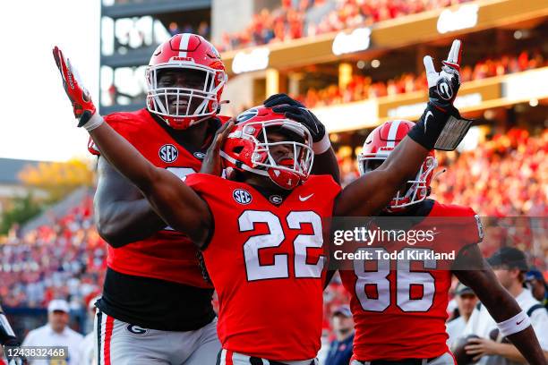 Branson Robinson of the Georgia Bulldogs reacts after a touchdown with teammates Amarius Mims and Dillon Bell in the second half against the Auburn...