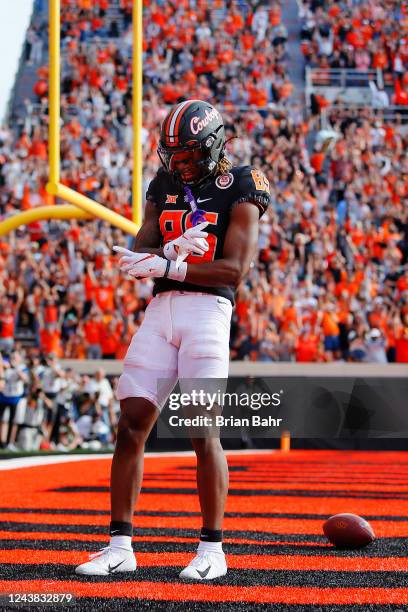 Wide receiver Jaden Bray of the Oklahoma State Cowboys celebrates a two-point conversion after a touchdown to tie the game against the Texas Tech Red...