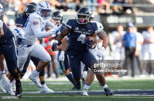 Calvin Tyler Jr., #4 of the Utah State Aggies rushes against the Air Force Falcons during the first half of their game on October 8, 2022 at Maverik...