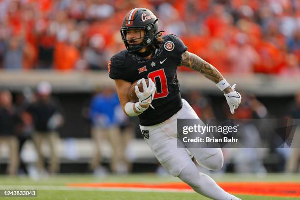 Linebacker Mason Cobb of the Oklahoma State Cowboys turns with an interception for a 13-yard return to set up the go-ahead field goal against the...