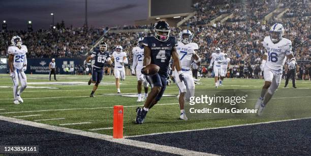 Calvin Tyler Jr., #4 of the Utah State Aggies rushes in for a touchdown against Jamari Bellamy, Trey Taylor, and Jayden Goodwin of the Air Force...