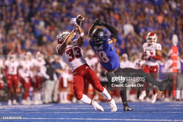 Defensive back Bralyn Lux of the Fresno State Bulldogs and wide receiver Billy Bowens of the Boise State Broncos go up for a pass during first half...
