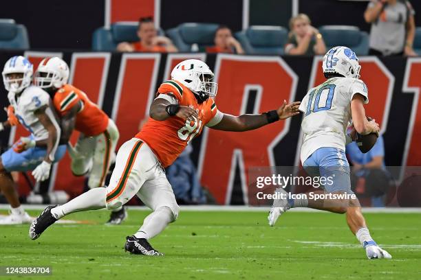 Miami defensive lineman Jared Harrison-Hunte pressures North Carolina quarterback Drake Maye in the fourth quarter as the University of Miami...