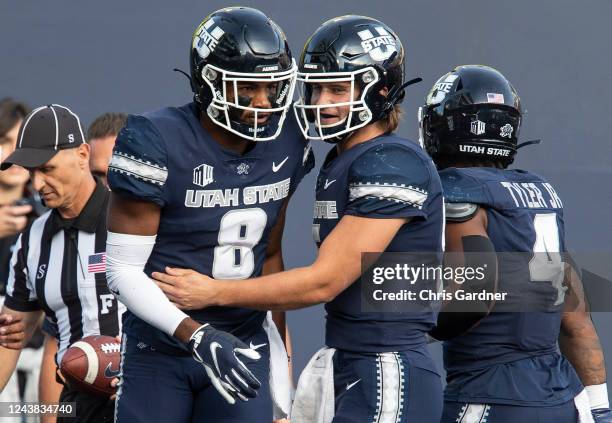 Cooper Legas of the Utah State Aggies congratulates teammate Brian Cobbs after he caught a touchdown pass against the Air Force Falcons during the...