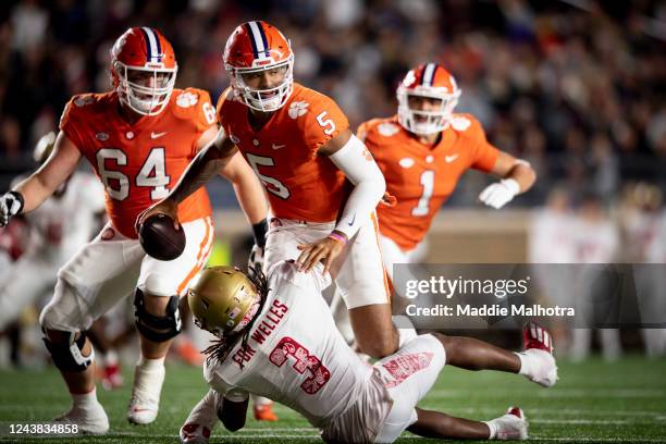 Uiagalelei of the Clemson Tigers is tackled by Peter Delaportas of the Boston College Eagles during the second half of a game at Alumni Stadium on...